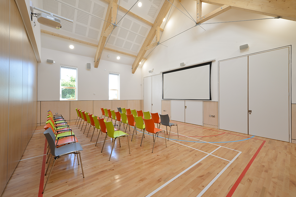 The main hall at Ochiltree Community Hub set as a cinema, with the projection screen and Sonance Mariner loudspeakers The main hall at Ochiltree Community Hub set as a cinema, with the projection screen and Sonance Mariner loudspeakers