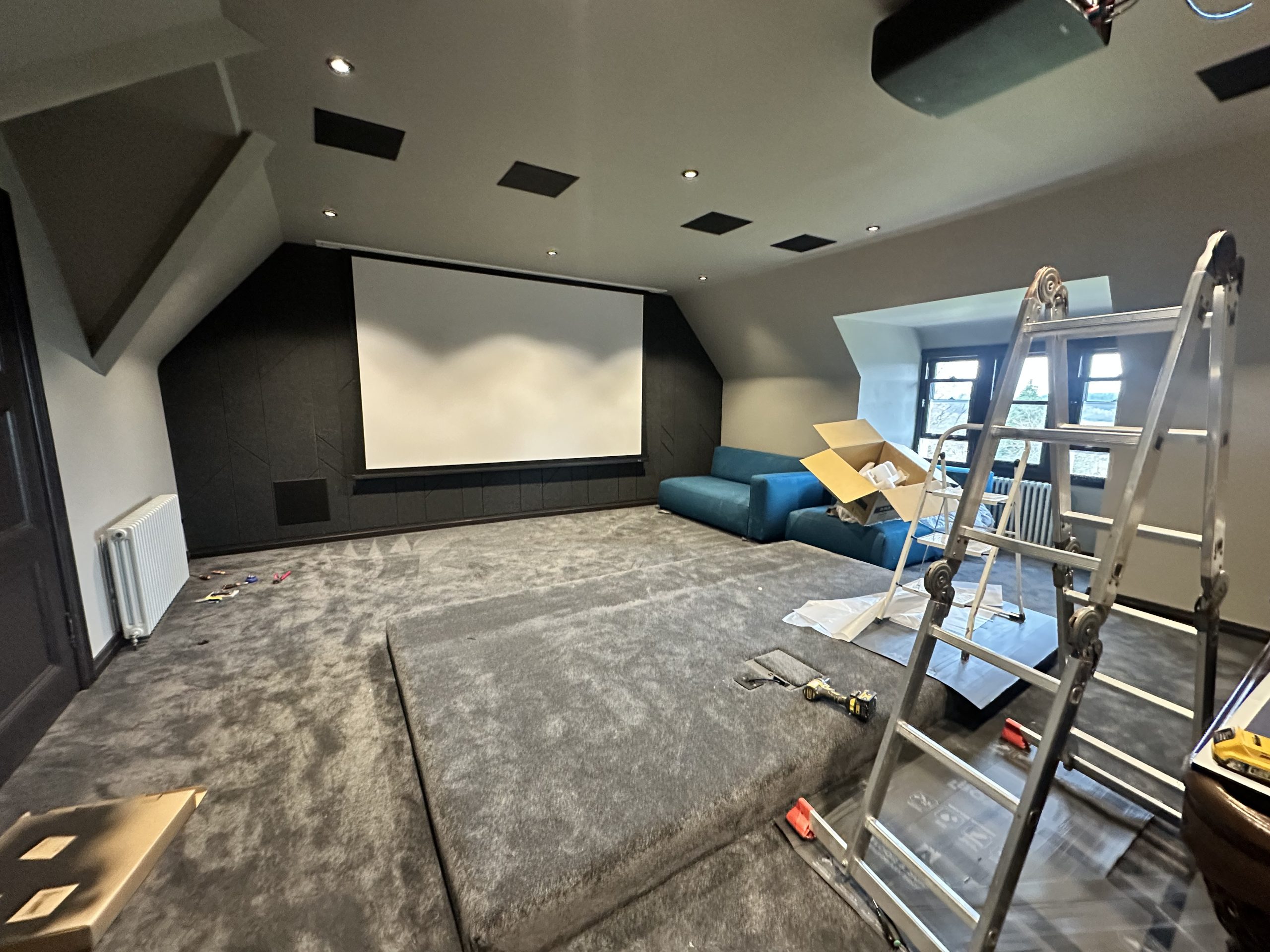 Lairds engineers fitting the screen wall in the top-floor cinema at Greystones