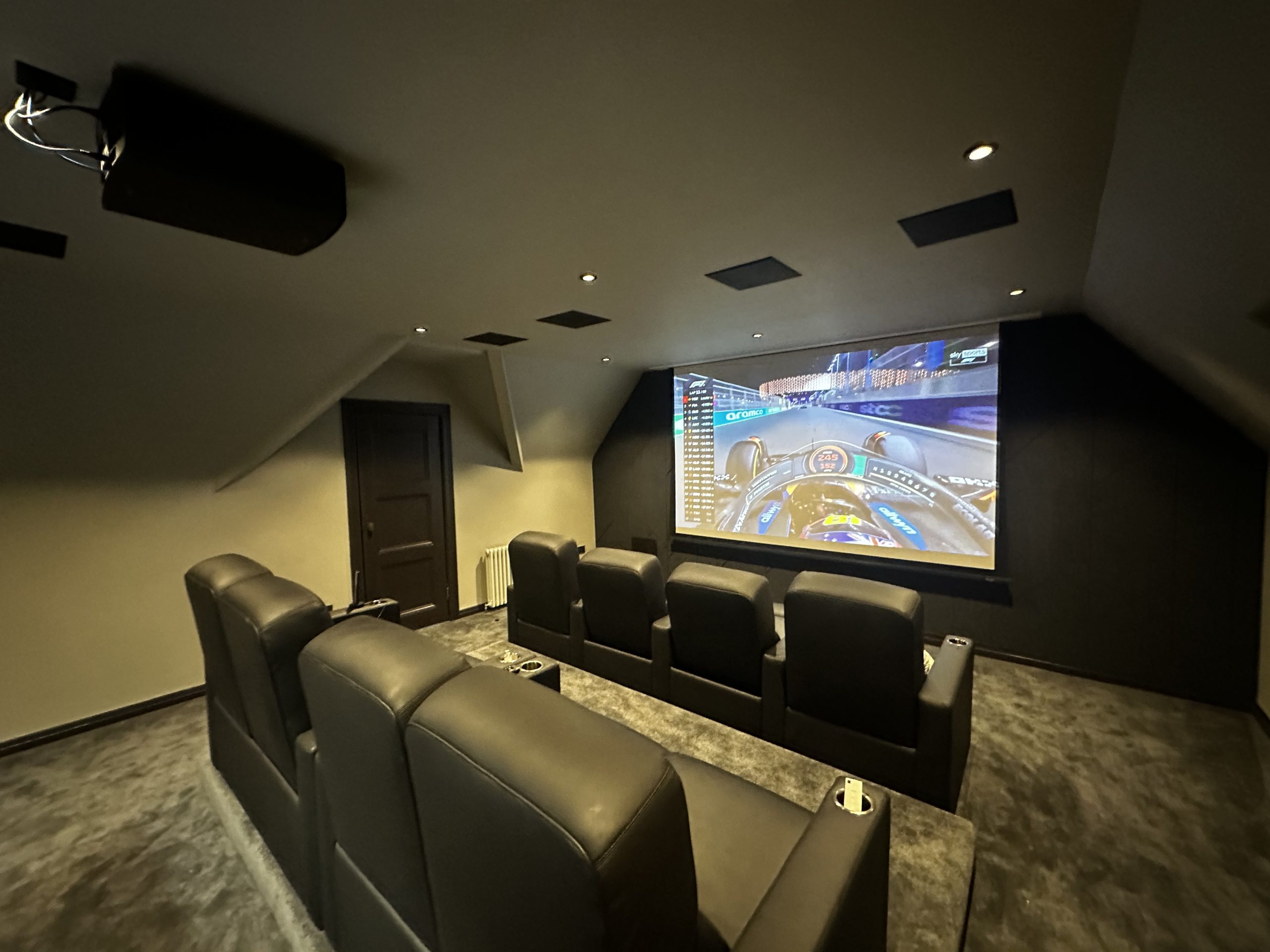 The finished cinema and games room at Greystones, Kilmacolm, with tiered seating and screen